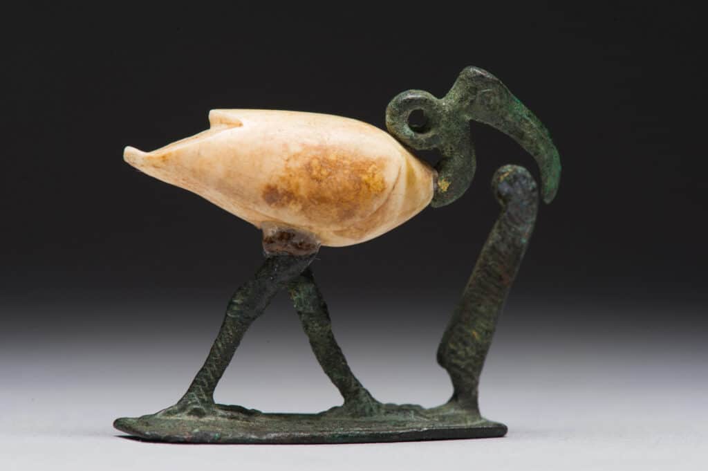 Figure of a striding ibis. Late Period to Ptolemaic Period, 664-30 BCE. Copper alloy, travertine, and gold. [ECM 1692]